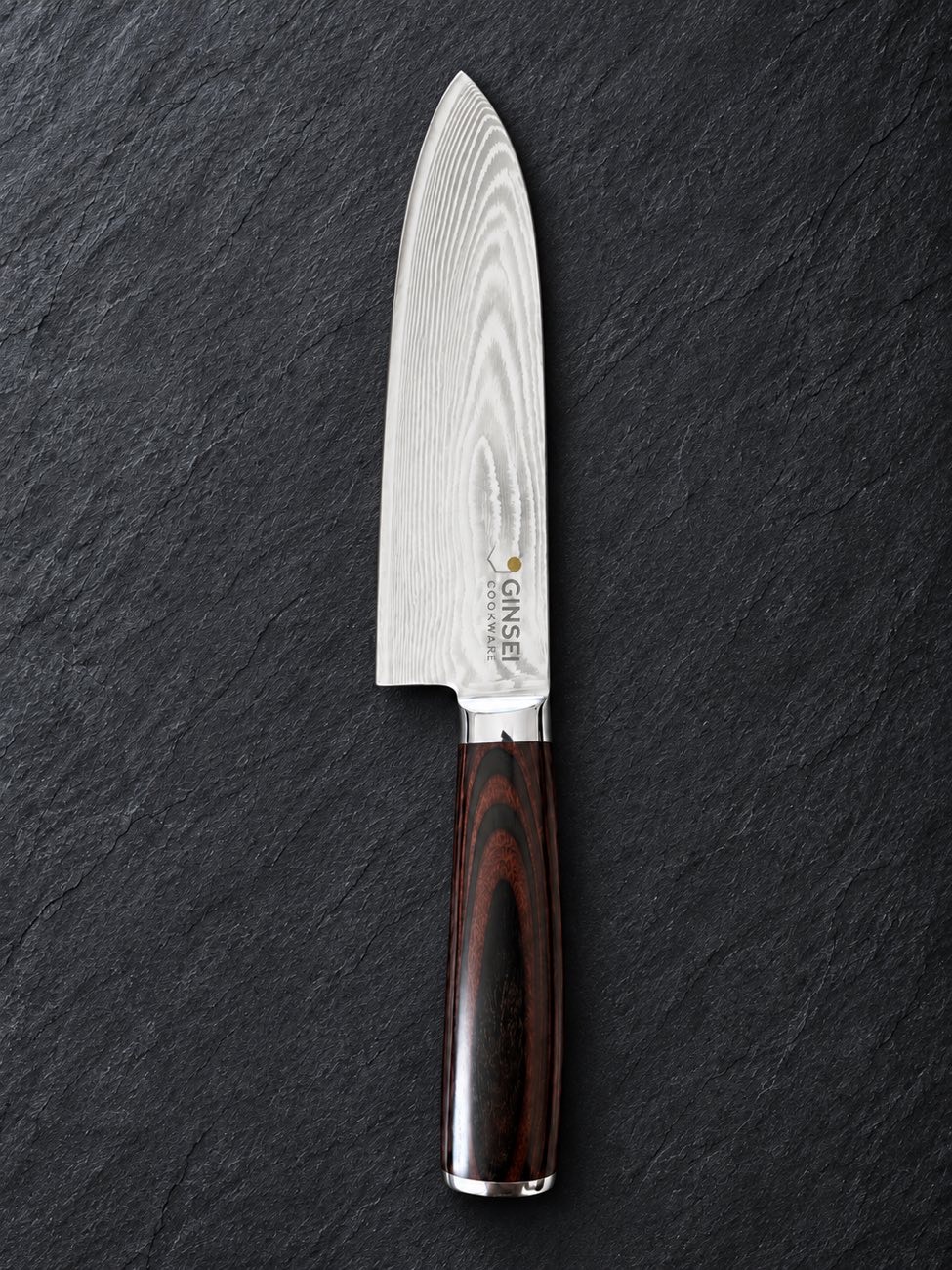 A pristine GINSEI Damascus santoku with a mirror edge